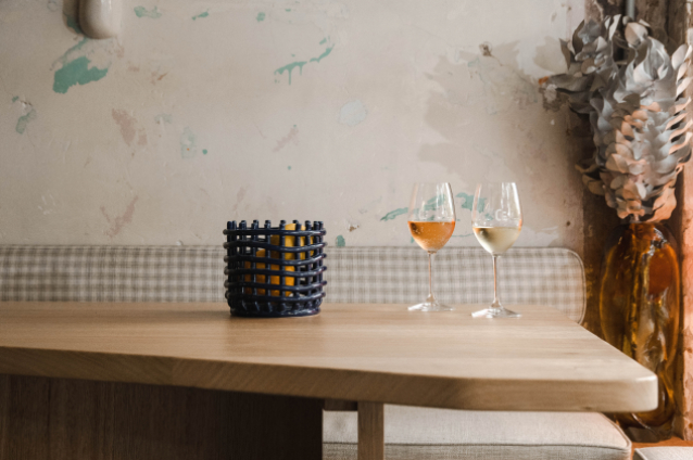 Wine glass sitting on table top with fruit basket for Renew Adelaide